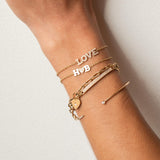 woman's wrist wearing a Zoe Chicco 14k Star Set Diamond Heart Padlock Bracelet