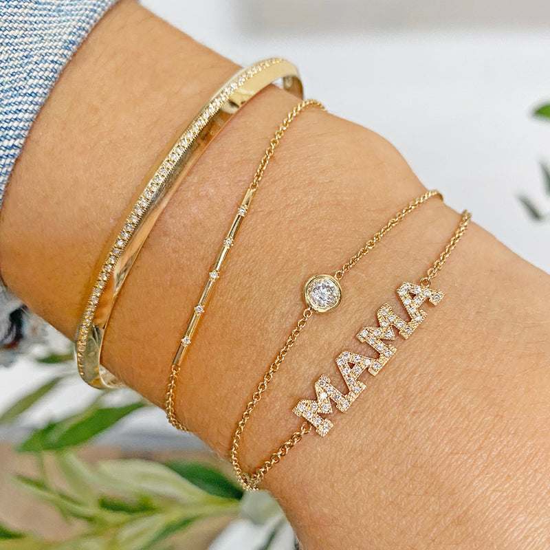 woman's wrist wearing Zoe Chicco 14k Gold Pave Diamond 4 Letter Personalized Bracelet