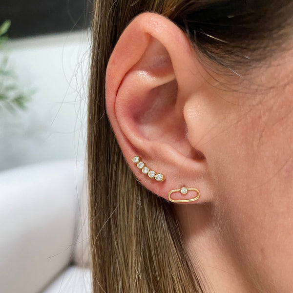 woman's ear wearing Zoë Chicco 14kt Gold 5 Diamond Bezel Curved Bar Stud Earrings