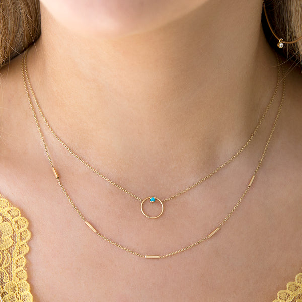 woman wearing Zoë Chicco 14kt Gold 5 Tiny Bar Station Necklace layered with a Medium Circle Prong Turquoise Necklace