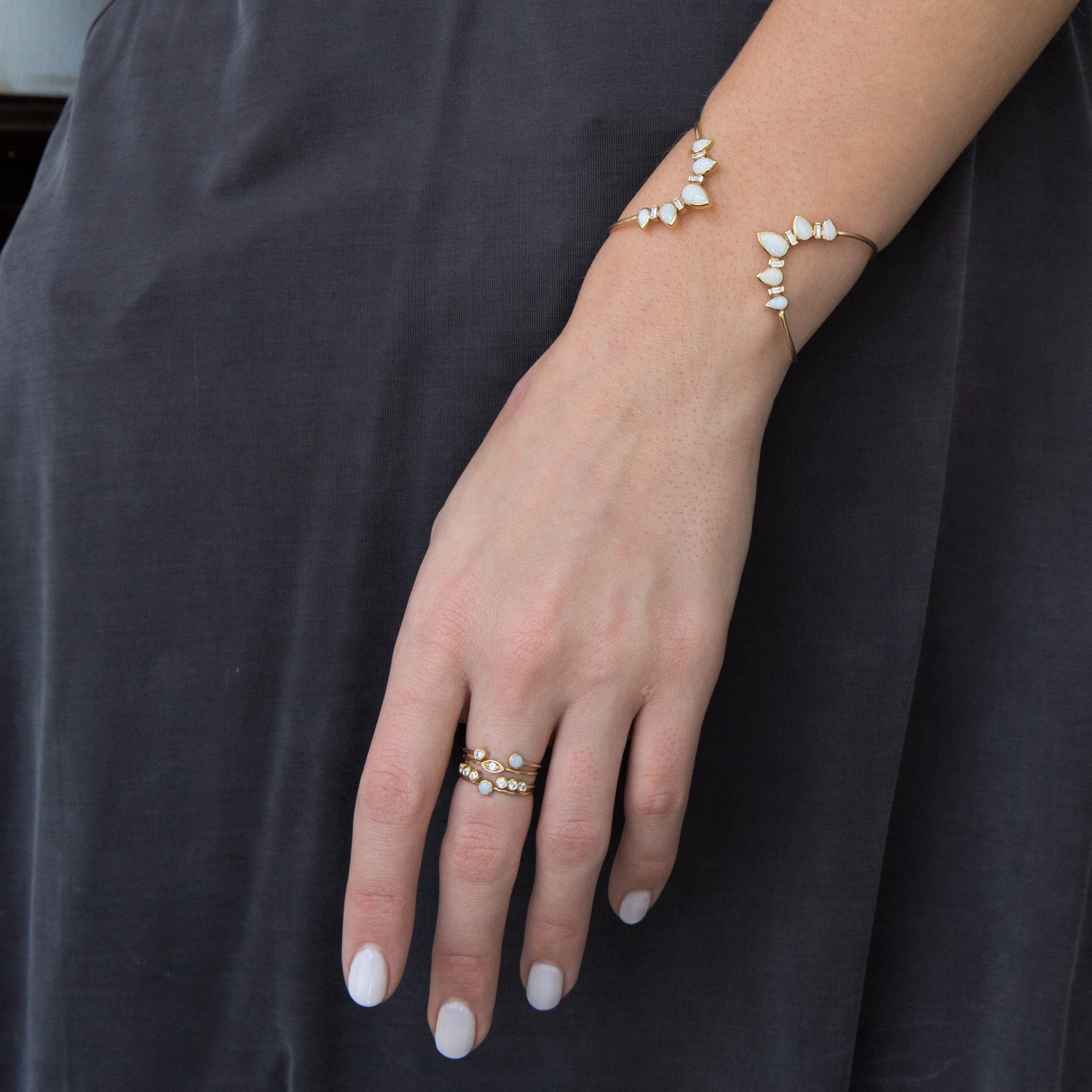 Girl in Black wearing Zoe Chicco opal rings and cuff