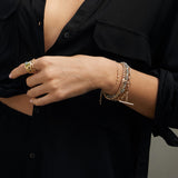 woman in black shirt wearing a Zoë Chicco 14k Gold Linked 5 Graduating Prong Diamond Bolo Bracelet on her wrist