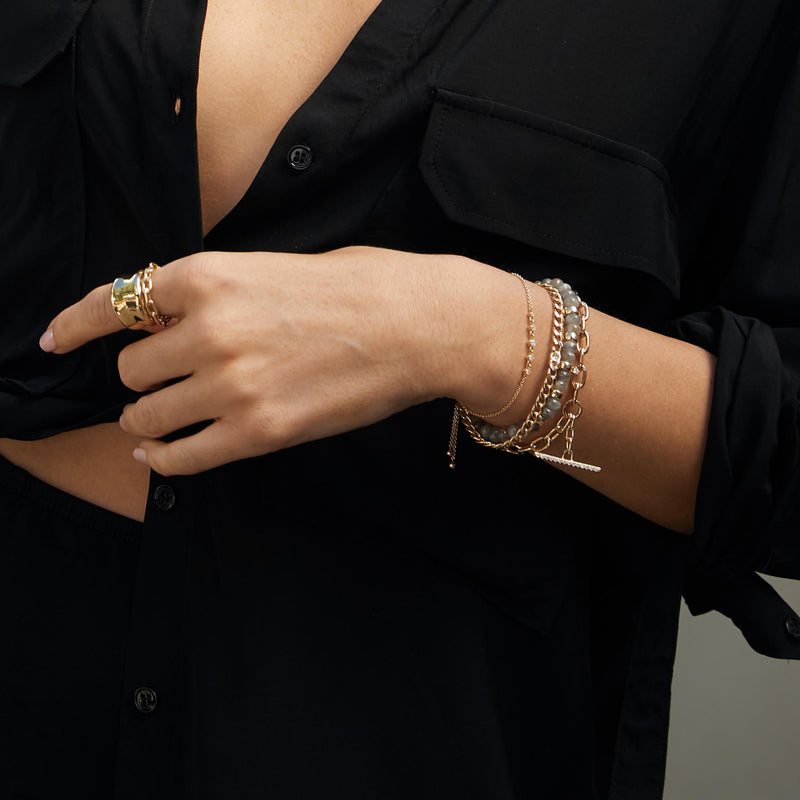 woman in black button up shirt wearing a Zoë Chicco 14k Gold XL Square Oval Link Pavé Diamond Toggle Bracelet