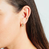 woman's ear wearing Zoë Chicco 14kt Gold Pear Diamond Chubby Huggie Hoop Earrings