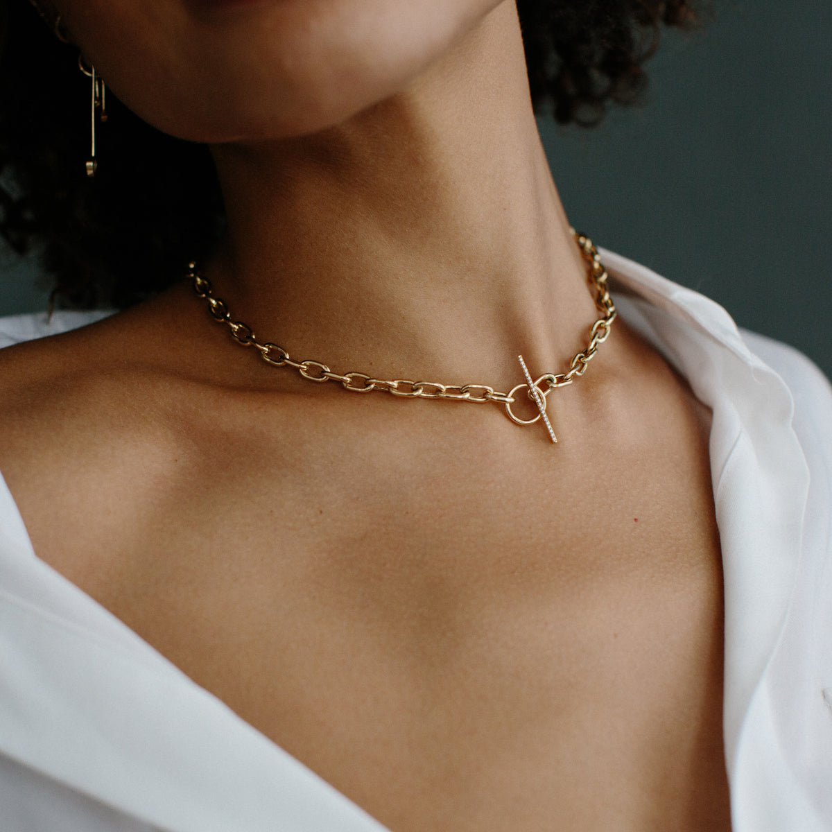 woman in white shirt top wearing Zoe Chicco 14k Gold Extra Large Square Oval Link Chain Pave Diamond Toggle Necklace