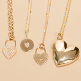 flat lay of Zoë Chicco 14kt Gold Heart Shaped Locket Necklace