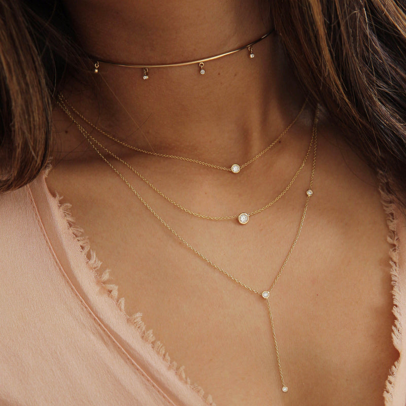 woman in pink frayed top wearing Zoe Chicco 14k Gold Off-Set Floating Diamonds Lariat Necklace