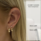 comparison image on a woman's ear of a Zoe Chicco 14kt Gold 4mm and 5mm Chubby Huggie for size reference