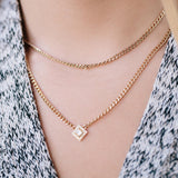 close up of a woman in grey sweater wearing a Zoë Chicco 14k Gold Small Curb Chain Necklace