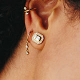 close up of ear with 3 gold and diamond earrings