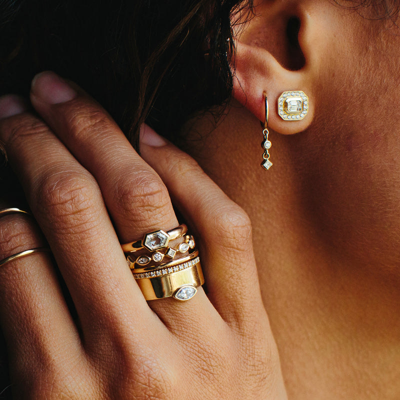 close up of woman's ear and hand wearing various Zoe Chicco 14kt gold mixed cut diamond jewelry