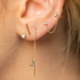 woman's ear wearing a Zoë Chicco 14k Gold Prong Diamond Double Stud Chain Earring