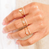woman's hand wearing three Zoe Chicco 14kt Gold Pave Diamond Open Double Band Rings