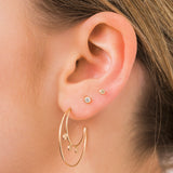 woman's ear wearing Zoë Chicco Classic 14kt Gold Large Diamond Bezel Stud with a Diamond Bezel Stud
