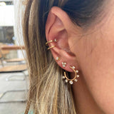 close up of woman's ear wearing Zoë Chicco 14kt Yellow Gold Graduated Prong Set Diamonds Front to Back Circle Hoop Earring