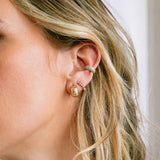 close up of woman's ear wearing a Zoë Chicco 14k Gold Scattered Star Set Diamonds Small Aura Huggie Hoop