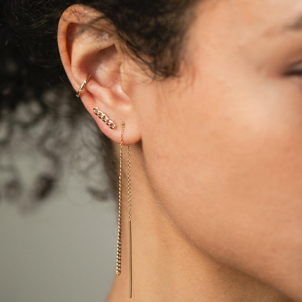 woman's ear wearing Zoë Chicco 14k Gold XS Curb Chain Drop Threader Earrings and Small Curb Chain Bar Stud Earring with a Scattered Diamond Ear Cuff