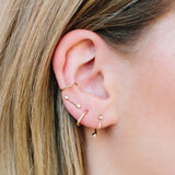 woman's ear wearing a Zoë Chicco 14k Gold 5 Diamond Thick Huggie Hoop Earring in her second piercing