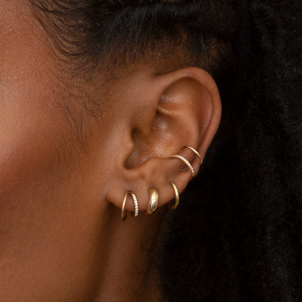 close up of woman's ear wearing Zoe Chicco 14kt Gold Double Wire Pavé Diamond Huggie Hoops