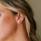 close up of a woman's ear wearing a Zoë Chicco 14k Gold Pavé Diamond Snake Ear Shield with a diamond bezel beaded ear cuff
