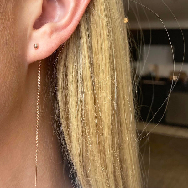 woman's ear wearing Zoe Chicco 14kt Gold Tiny Ball Threader Earrings
