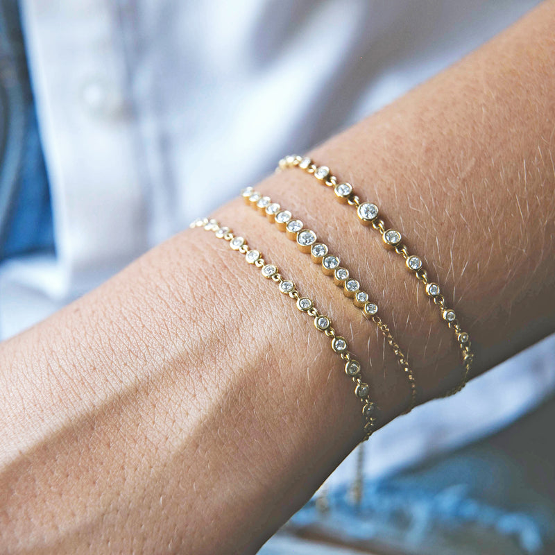 Zoë Chicco 14kt Gold Linked Diamond Tennis Bolo Bracelet with two other bolo bracelets on a woman's wrist