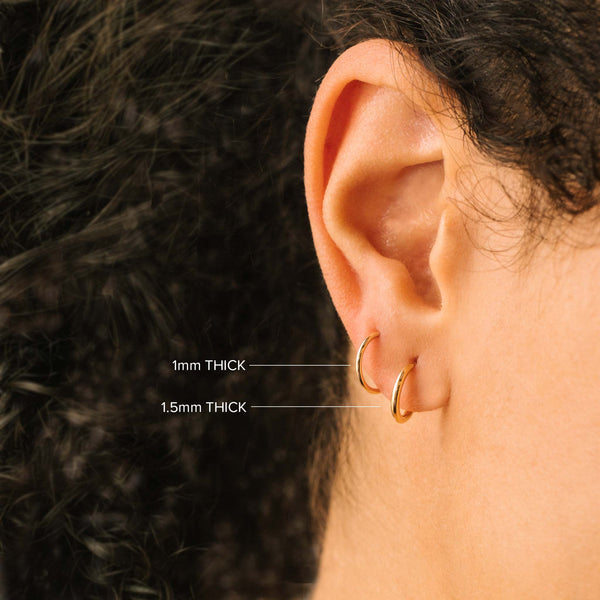 comparison image of two hoop thicknesses of Zoë Chicco 14k Gold Tiny Huggie Hoop Earrings