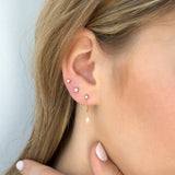 woman's ear wearing Zoë Chicco 14kt Gold Itty Bitty Pave Diamond Star Stud Earring