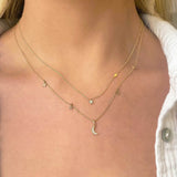 woman in white shirt wearing Zoë Chicco 14k Gold Itty Bitty Diamond Star Necklace with Off-Set Lightning Bolt