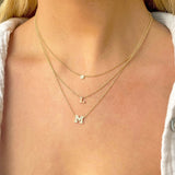 woman wearing Zoë Chicco 14kt Gold Initial Letter Necklace layered with a Large Pave Diamond Initial Necklace and an Itty Bitty Pave Diamond Disc Necklace