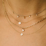 woman wearing a Zoë Chicco 14k Gold Itty Bitty Mushroom Necklace layered with three other necklaces