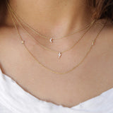 woman in white top wearing Zoë Chicco 14kt Gold Itty Bitty Pave Diamond Lightning Bolt Necklace