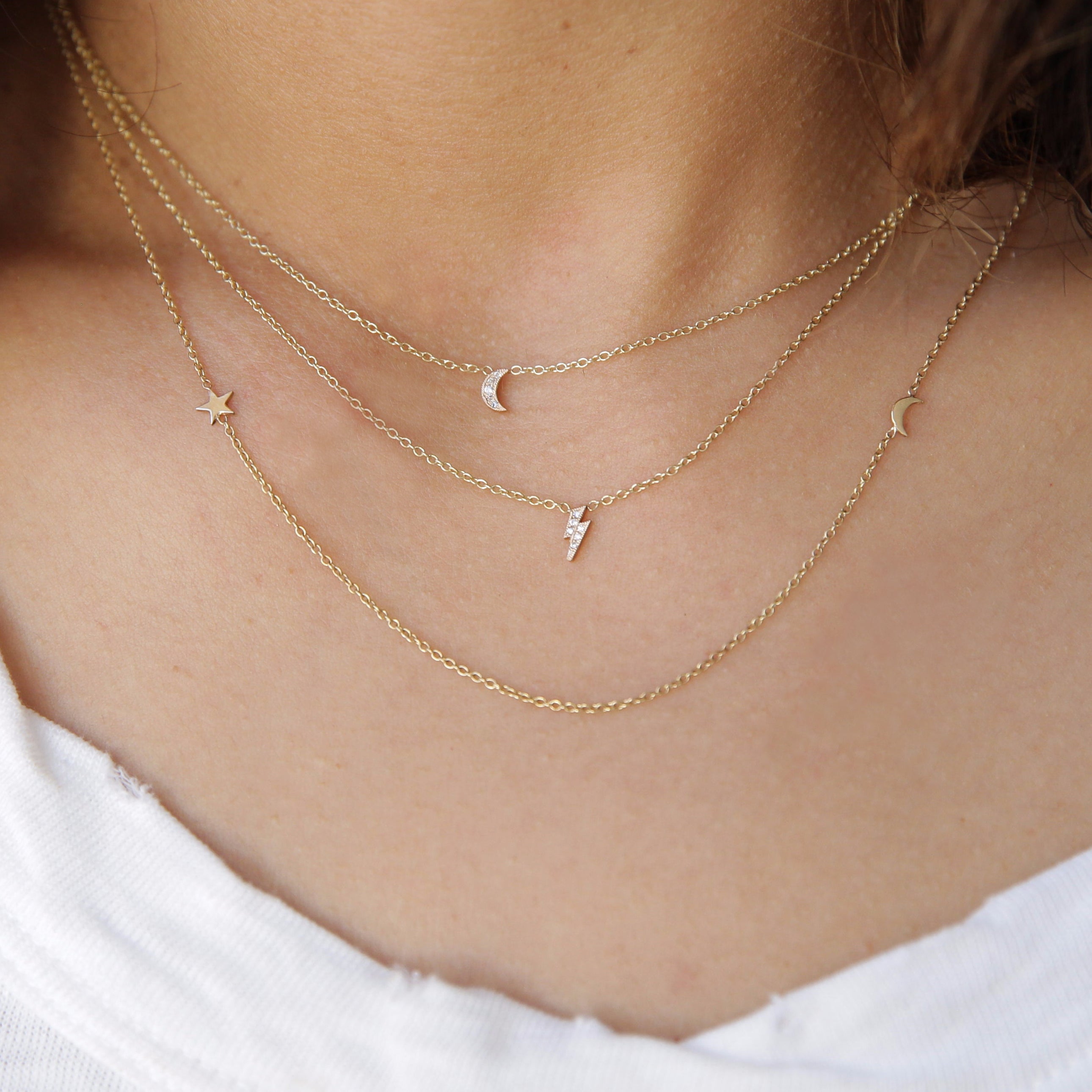 woman in white top wearing Zoë Chicco 14kt Gold Itty Bitty Pave Diamond Crescent Moon Necklace