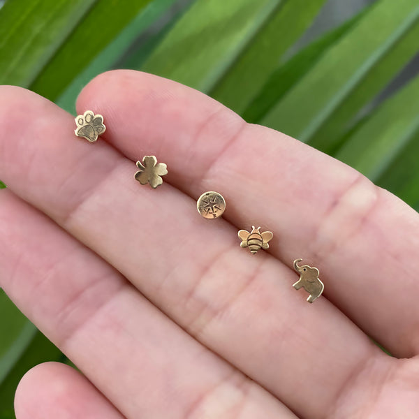 row of Zoe Chicco 14kt Gold Itty Bitty studs in hand