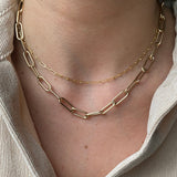 woman in beige top wearing Zoe Chicco 14 karat gold small and large paperclip chain necklaces layered together