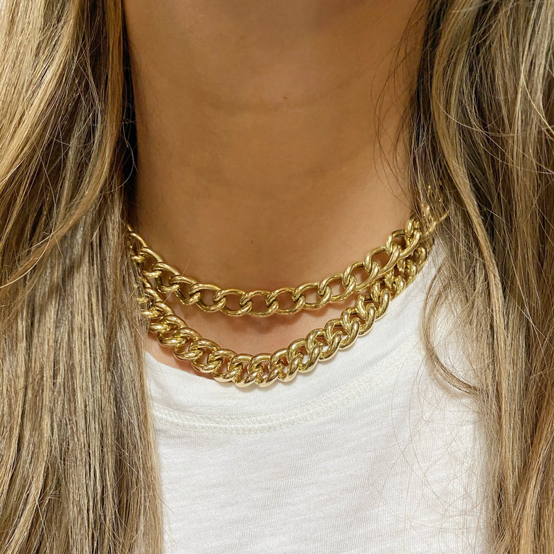 woman wearing Zoë Chicco 14kt Gold XXL Open Link Curb Chain Necklace layered with an XXL Thick Link Curb Chain Necklace