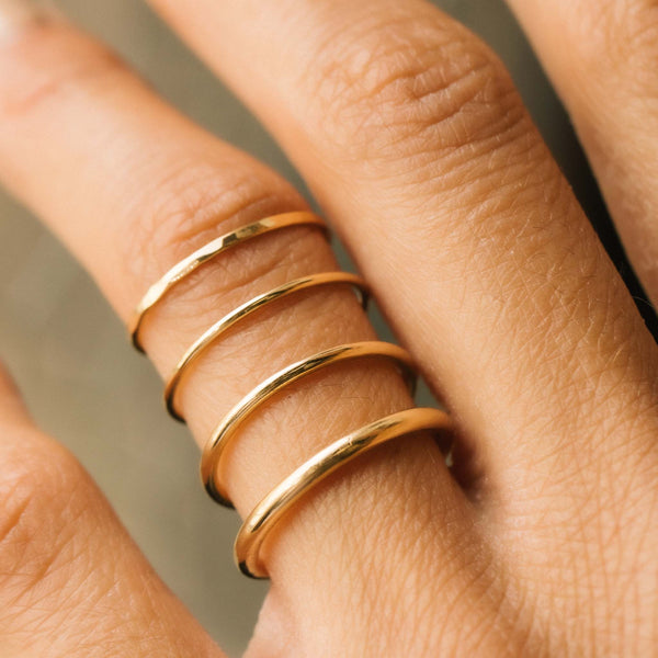 comparison image of a Zoë Chicco 14k Gold Thin Hammered Band Ring with three other rounded band rings