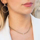 woman in a white blazer wearing Zoë Chicco 14kt Gold Medium Curb Chain Floating Diamond Necklace