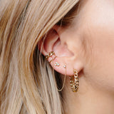 woman wearing Zoë Chicco 14kt Medium Curb Chain Ear Cuff with a curb chain hoop, mixed prong diamond stud, and diamond stud chain earring with ear cuff