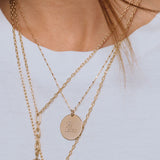 close up of woman in white shirt wearing Zoë Chicco 14k Gold Medium " YOU ARE LOVED" with Diamonds Disc Pendant Square Bead Chain Necklace around her neck
