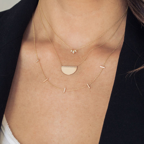 woman wearing Zoë Chicco 14kt Gold 5 Pavé Diamond Vertical Tiny Bar Station Necklace with a Medium Pave Diamond Horizon Necklace, and a Marquise Diamond Fan Necklace