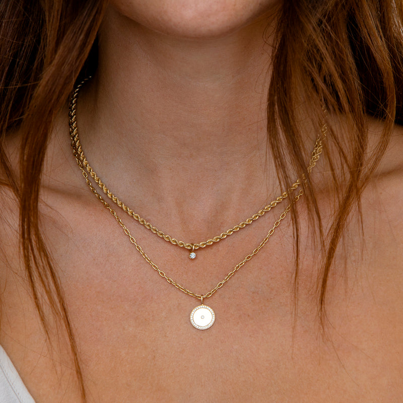 close up of woman's neck wearing Zoë Chicco 14k Gold Medium Diamond Disc with Diamond Border Square Oval Chain Necklace