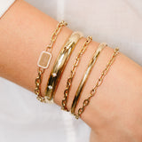 close up of woman's wrist wearing Zoe Chicco 14kt Gold Half Round Star Set Diamond Cuff Bracelet