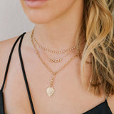 woman wearing a Zoë Chicco 14k Gold Diamond Mosaic Brushed Gold Shield Clip on Pendant hanging from a medium square oval link chain
