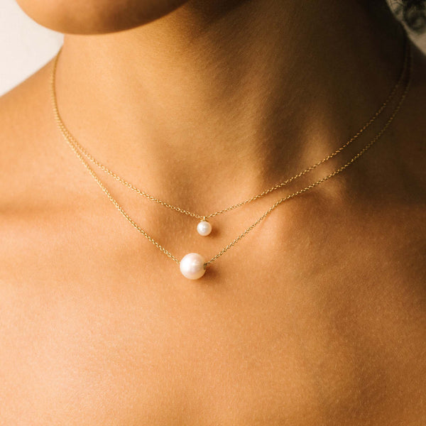 comparison image of a Zoë Chicco 14k Gold Small Pearl Pendant Necklace and 14k Single Large Pearl Necklace layered together