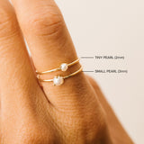 comparison image of a 2mm and 3mm Zoë Chicco 14k Gold Single Prong Pearl Rings stacked together on a finger