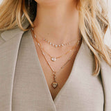 woman in a grey vest and jacket wearing a Zoë Chicco 14k Gold One of a Kind .84 ctw Rose Cut Round Diamond on Small Paperclip Chain Necklace layered with two diamond necklaces