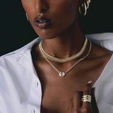 woman in white unbuttoned shirt wearing wearing a Zoë Chicco One of a Kind 14k Gold Hexagon Rose Cut Diamond on Medium Curb Chain Necklace layered with a Double Wide Curb Chain Necklace
