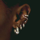 close up of woman's ear wearing Zoë Chicco 14k Gold Prong Diamond Half Round Huggie Hoop Earrings