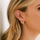 close up of woman wearing a Zoë Chicco 14k Gold Medium Aura Hoop Earring with a 14k Gold Small Aura Huggie Hoop